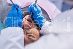 Close up of doctor giving dental treatment to man