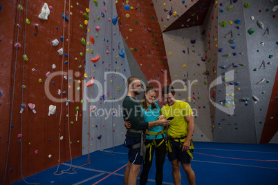 Trainer showing mobile phone to athletes in club