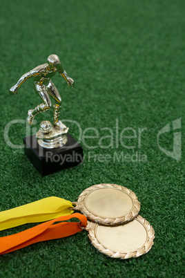 Trophy and medals on artificial grass