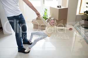 Father and daughter having fun in living room