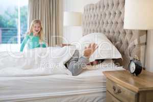 Father and daughter having fun on bed