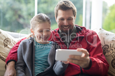 Father and daughter using mobilephone