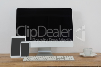 Various electronic gadgets and coffee on table