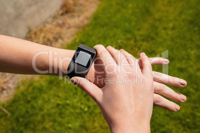 Woman using smartwatch in the gym