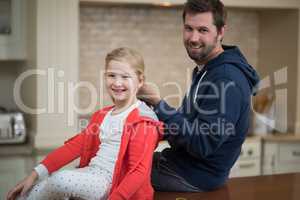 Father making daughters hairstyle at home