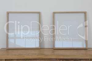 Frames arranged on wooden table