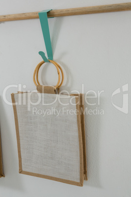 Bag hanging on wooden rod