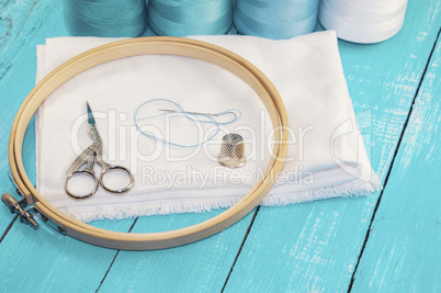 wooden round embroidery frame and white fabric for cross stitchi