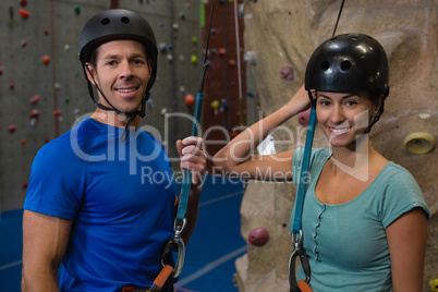 Portrait of athletes in sports helmet standing by climbing wall