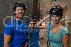 Portrait of athletes in sports helmet standing by climbing wall