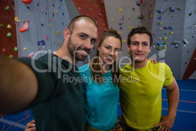 Portrait of trainer and athletes standing in gym