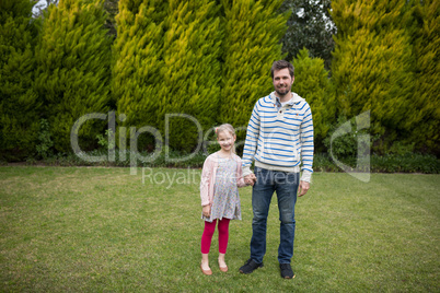 Young girl and father holding hands