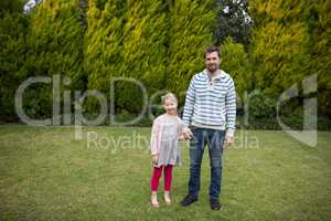 Young girl and father holding hands