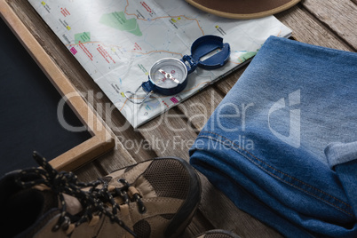 Apparels and travelling accessories on wooden plank