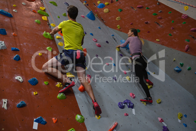 Athletes rock climbing in fitness studio