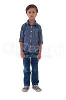 Boy standing against white background