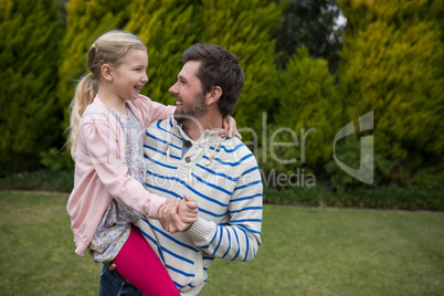 Young girl dancing with her fathers shoulders