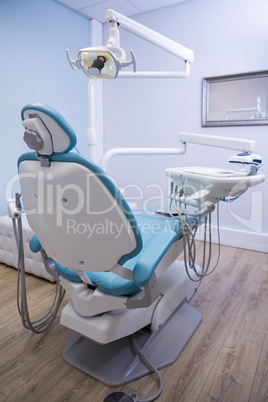 Dentist chair with medical equipment in clinic