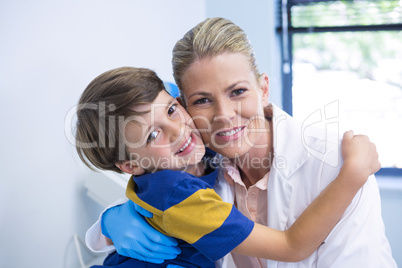 Portrait of smiling dentist with boy