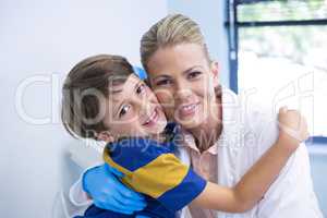 Portrait of smiling dentist with boy