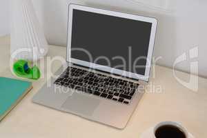 Laptop and office accessories on table
