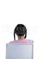 Girl sitting on chair against white background