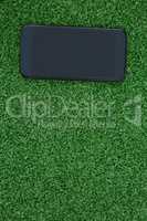 Mobile phone on artificial grass