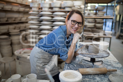 Portrait of female potter molding a clay