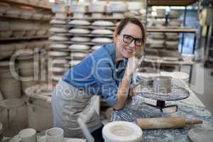 Portrait of female potter molding a clay