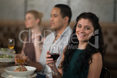 Portrait of beautiful woman dining with her friends