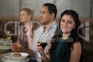 Portrait of beautiful woman dining with her friends