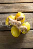 Lemons and ginger on wooden table