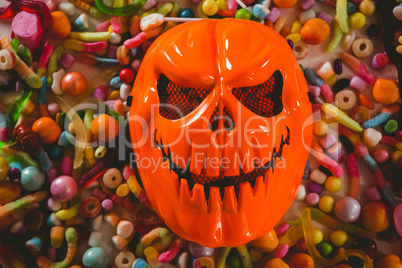 Overhead view of monster mask with various candies