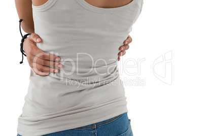 Mid section of woman hugging self