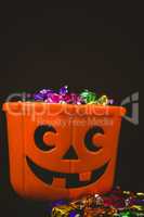 Close up of bucket with colorful chocolates during Halloween