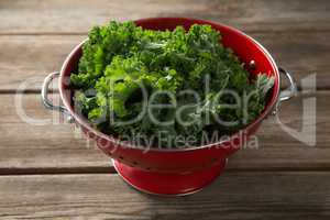 Close-up of kale in colander on table