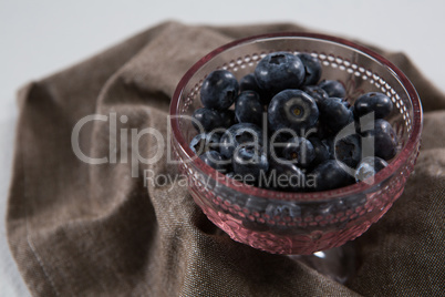 Blueberries in bowl on a textile