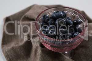 Blueberries in bowl on a textile