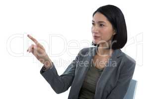 Businesswoman touching invisible screen