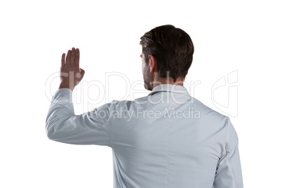 Male doctor using invisible screen against white background