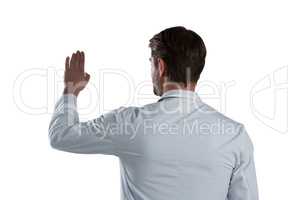 Male doctor using invisible screen against white background