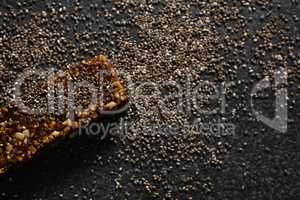 Granola bar with grains on black background