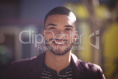 Close up of smiling young man on sunny day