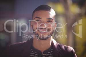 Close up of smiling young man on sunny day