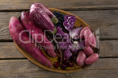 Various vegetables in a tray on wooden table