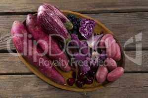 Various vegetables in a tray on wooden table