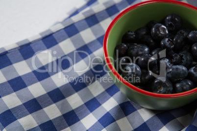 Blueberries in bowl on a textile