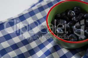 Blueberries in bowl on a textile