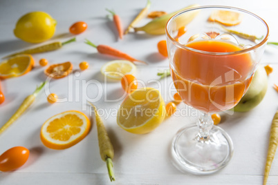 Orange juice with fruits on table