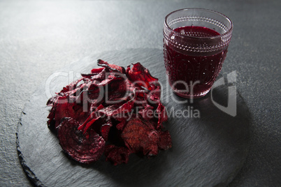 Juice glass with beetroot on plate